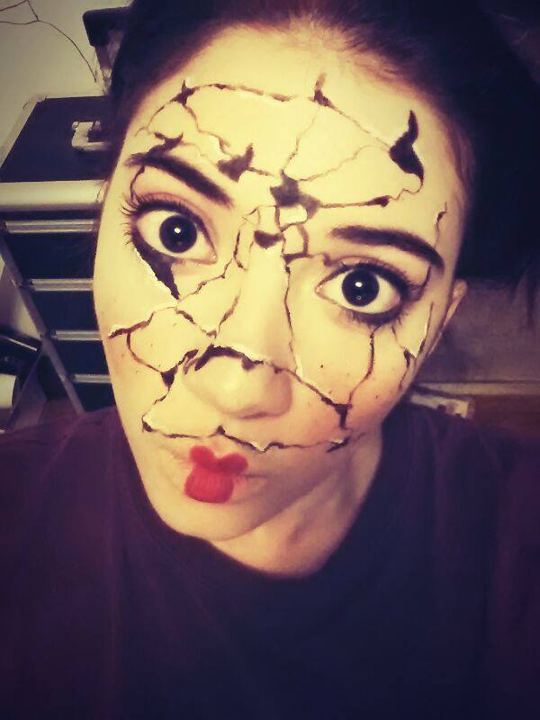Lexi in cracked porcelain doll makeup with wide eyes