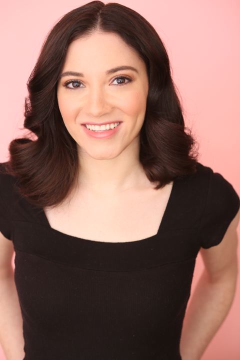 Headshot of Lexi smiling against a pink backdrop